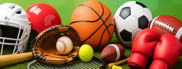 An assortment of sports equipement: basketball, soccer ball, tennis ball and racket, baseball bat, ball and glove, football helmet and boxing gloves An assortment of sports equipement: basketball, soccer ball, tennis ball and racket, baseball bat, ball and glove, football helmet and boxing gloves